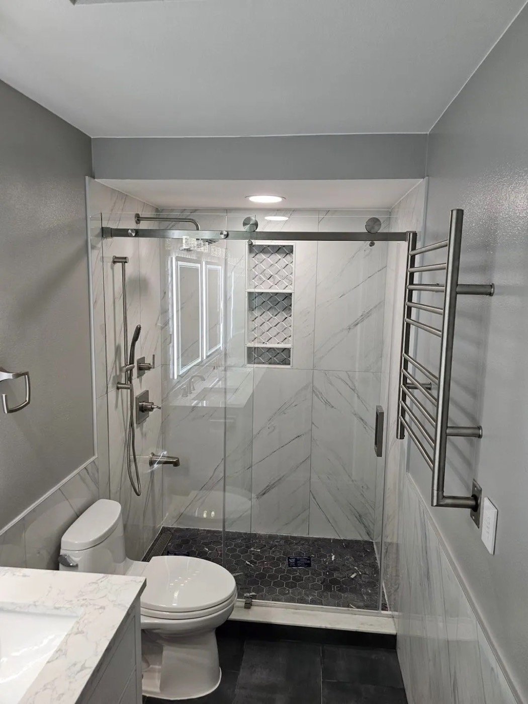 Walk-in tile shower with glass door