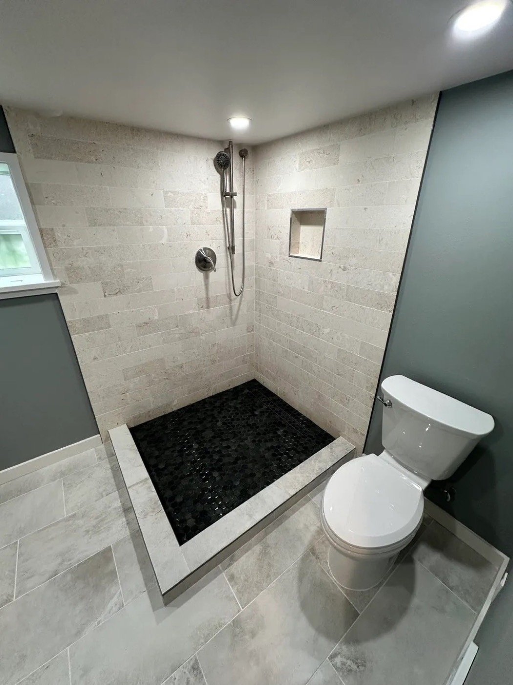 Walk-in shower with pebble tile floor