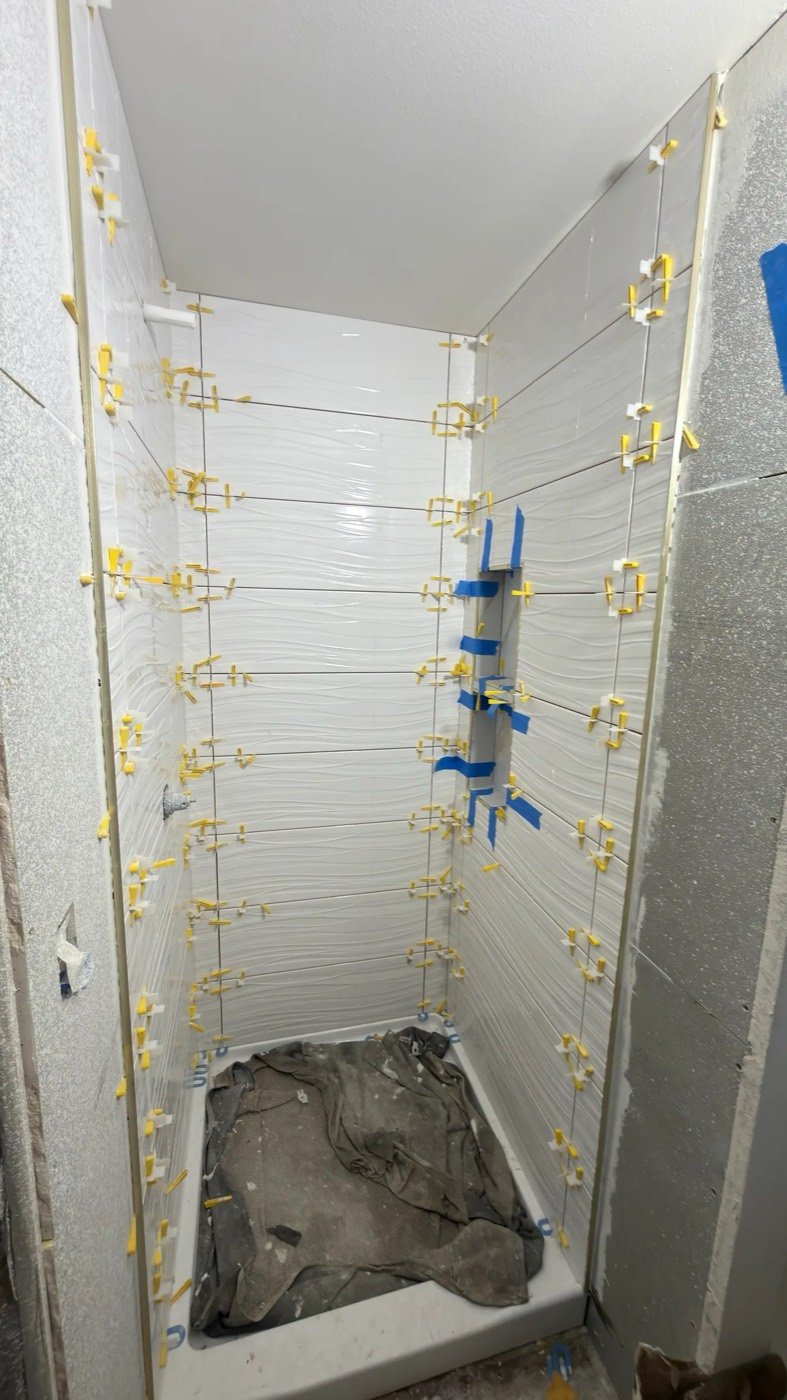 Tile leveling system on a shower wall
